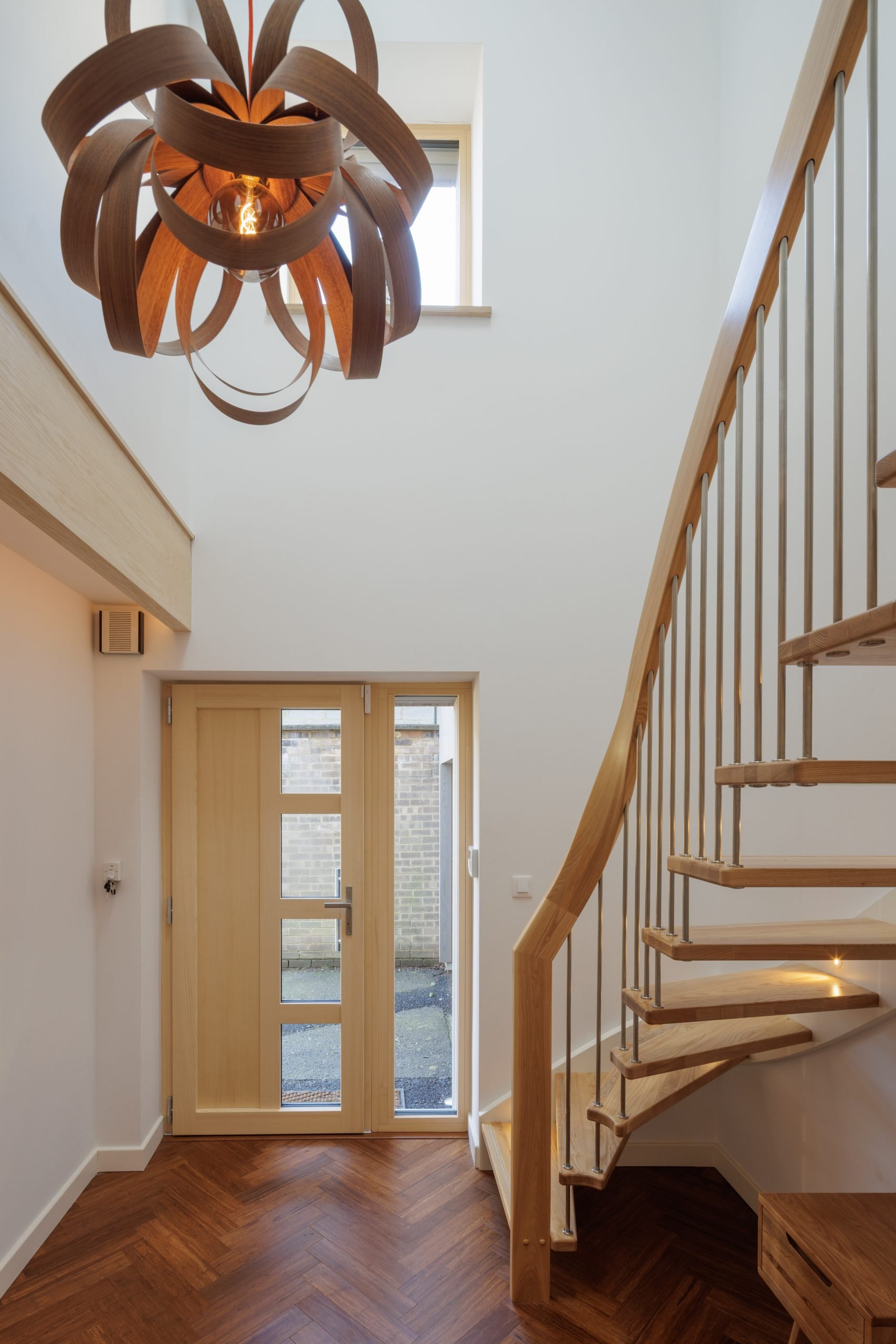 A spiral-esque staircase in a hallway.