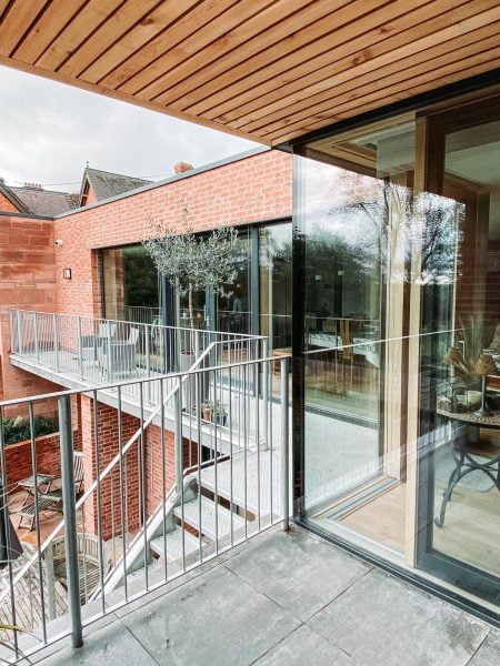 Passivhaus project by ecoHaus - external view of stairs to upper floor with wooden features