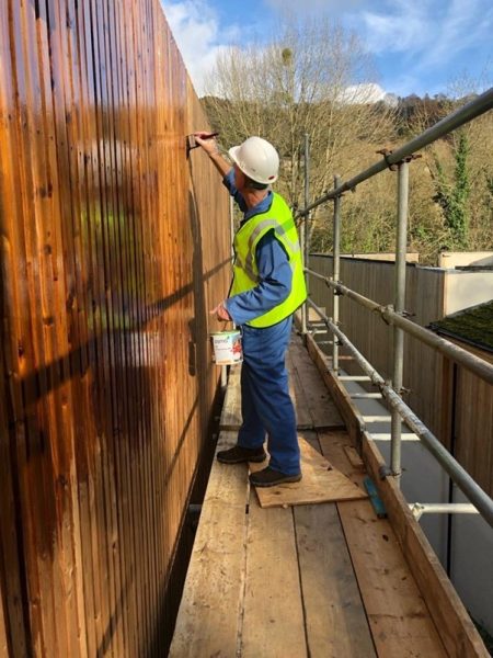 An old house renovation project with the outside wooden walls being painted
