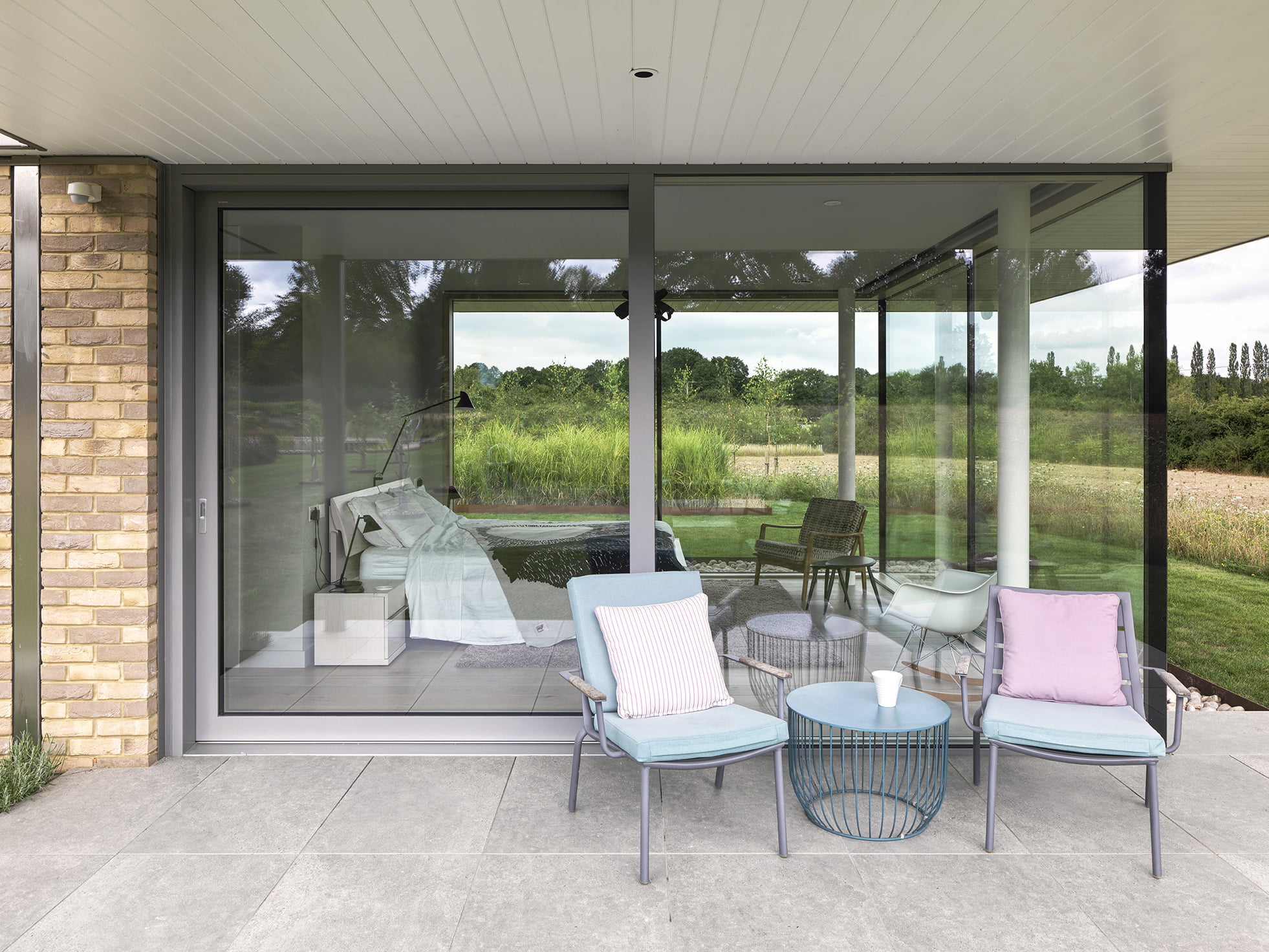 A patio area with two small chairs and a coffee table.